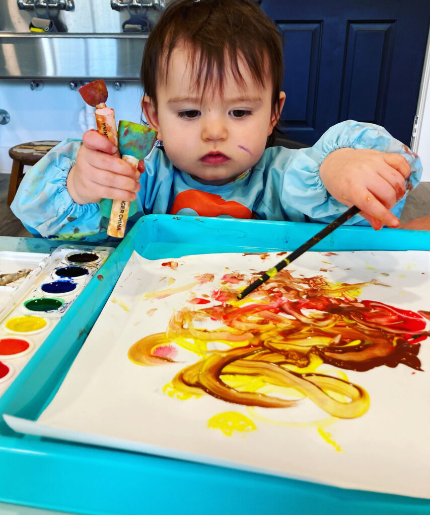 Child painting at Little Beasties Art Studio