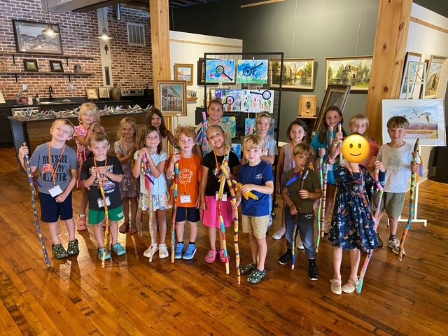 Little Beasties art class group holding their decorated walking sticks in the studio